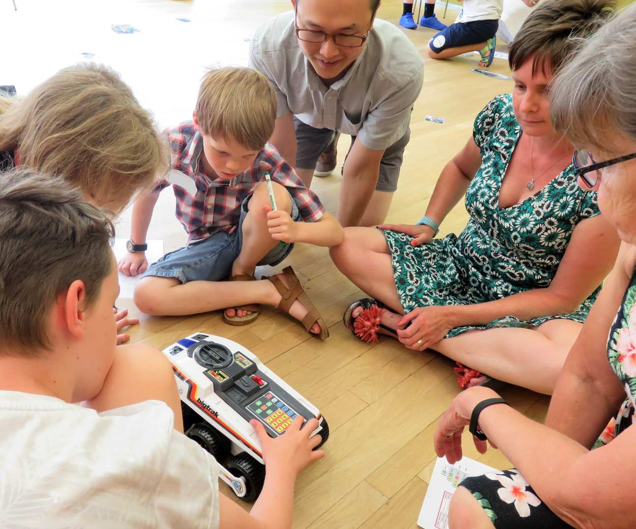 Children and parents programming a Big Trak electronic vehicle
