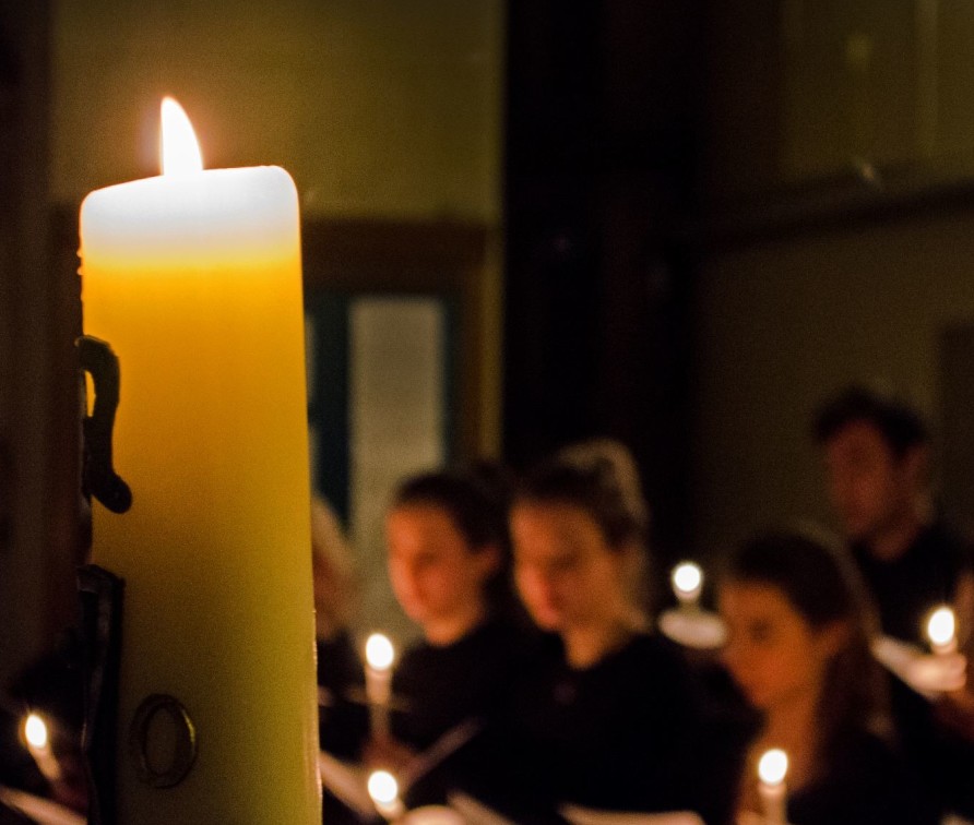 picture of choir singing and candle